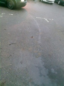 A trail of gasoline caused by a leaking fuel pipe